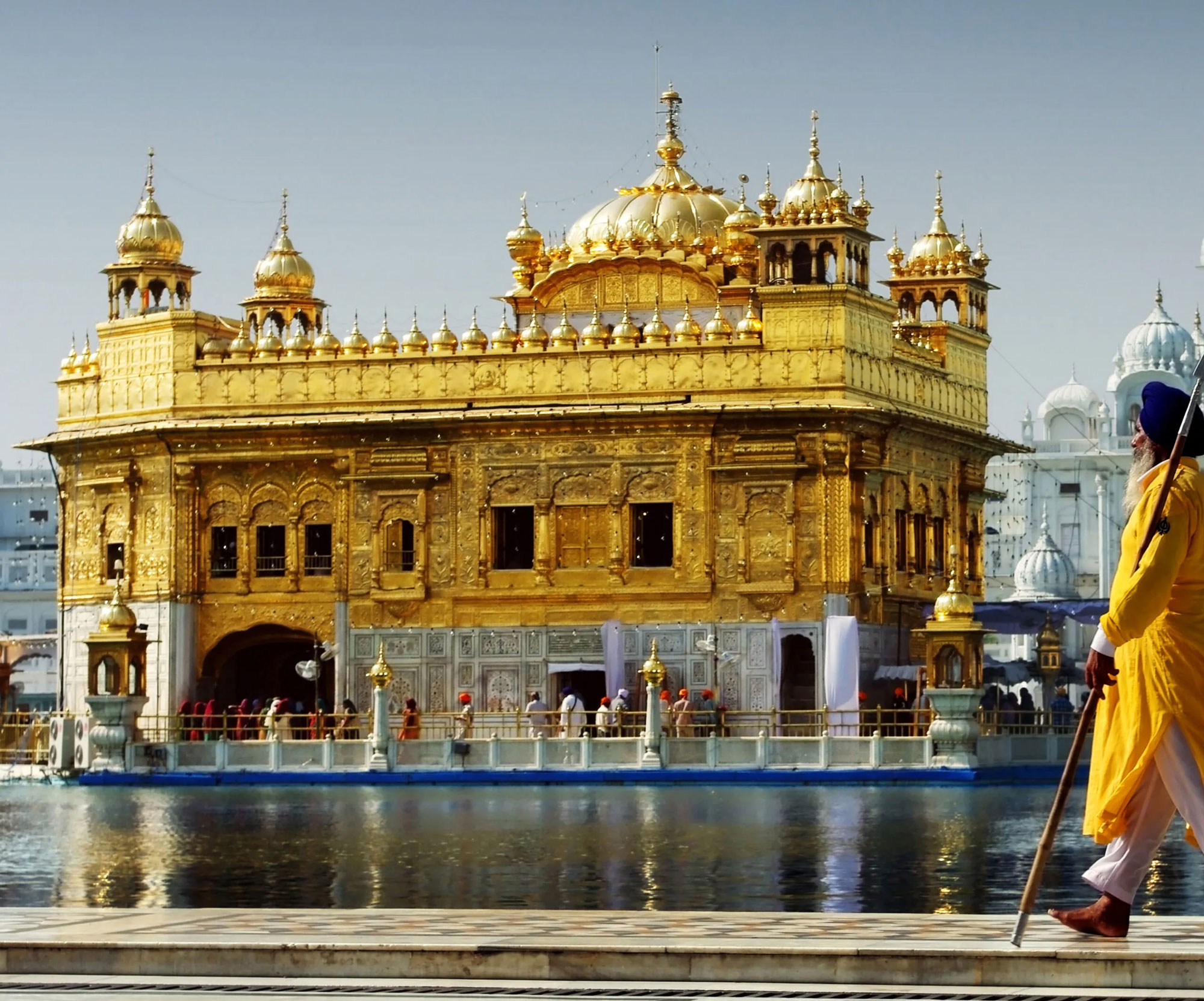 The Golden Temple with a Sikh guard in orange robes